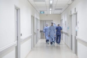 Doctor's walking down a West Virginia hospital hall with their back towards patient