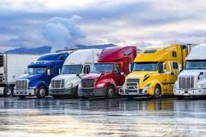 Row of colorful tractor trailers in West Virginia parking lot