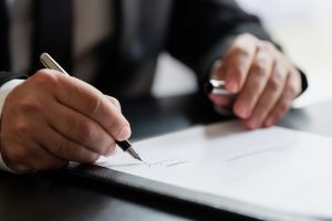 WV Car Accident Lawyer Signing Legal Documents