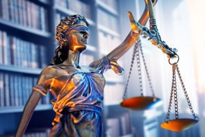 lady justice in front of personal injury lawyer's library
