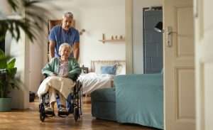 Caregiver doing regular check-up of senior client in West Virginia nursing home.