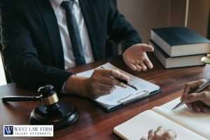 Injury attorney meeting with a client to review legal documents and discuss a personal injury claim in a law office setting