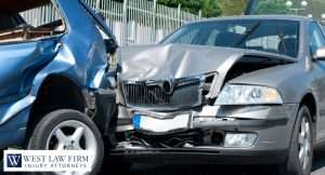 Close-up of two damaged vehicles after a rear-end car accident, showing crushed bumpers and front-end damage for a personal injury claim
