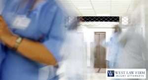Blurred hospital hallway with healthcare workers, representing medical malpractice concerns and legal support for an injury claim